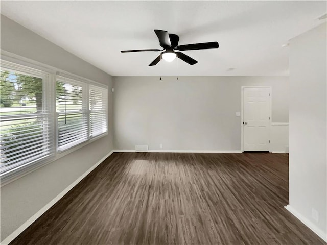 spare room with ceiling fan and dark hardwood / wood-style flooring