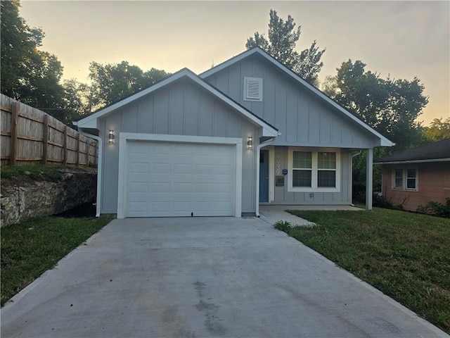 view of front facade with a garage and a lawn