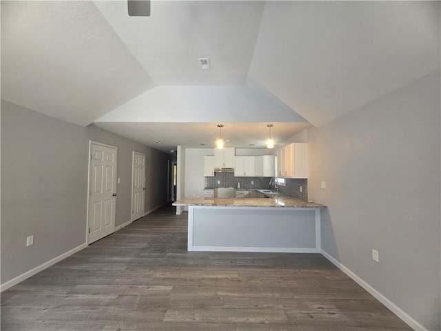 kitchen featuring sink, decorative backsplash, white cabinets, decorative light fixtures, and kitchen peninsula