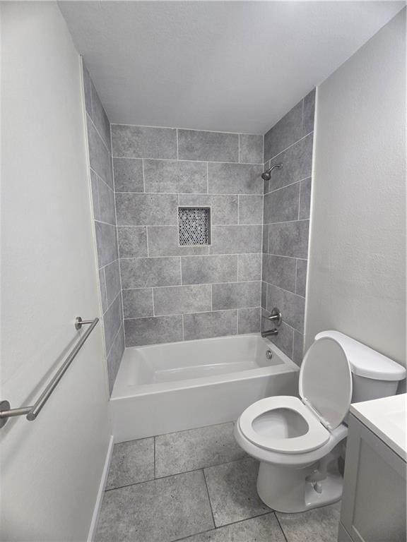 full bathroom with tile patterned flooring, vanity, toilet, and tiled shower / bath