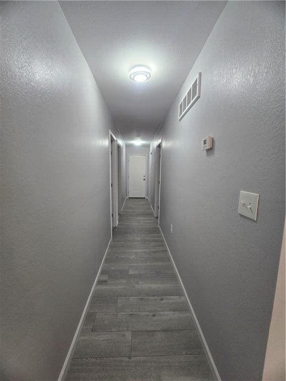 corridor featuring dark hardwood / wood-style floors