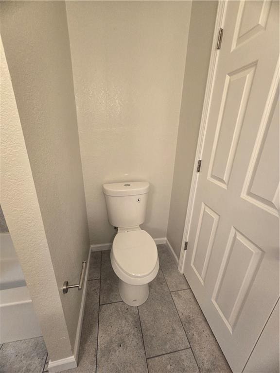 bathroom featuring tile patterned flooring and toilet