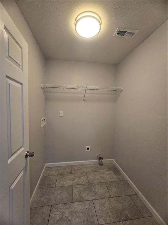 clothes washing area featuring washer hookup, electric dryer hookup, and a textured ceiling