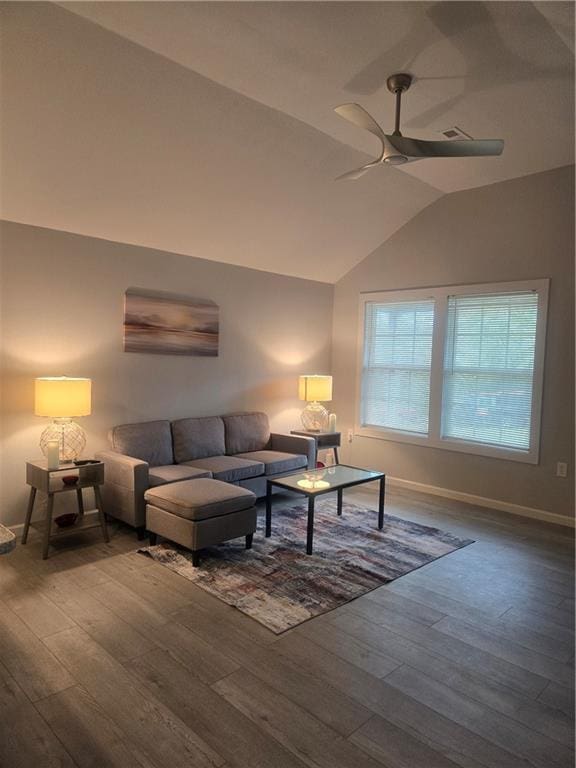 living room with hardwood / wood-style flooring, vaulted ceiling, and ceiling fan