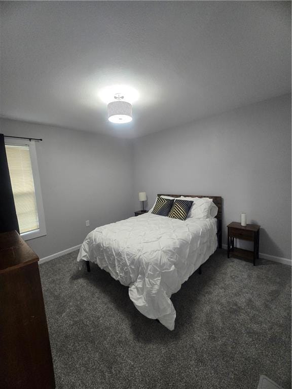 bedroom with dark colored carpet