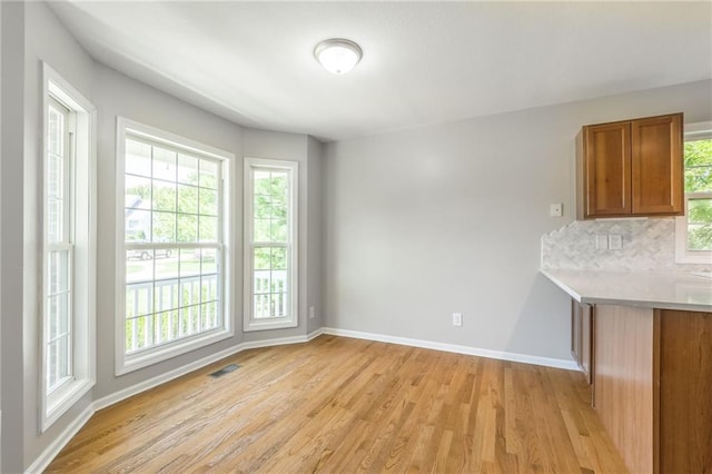 unfurnished dining area with light hardwood / wood-style floors