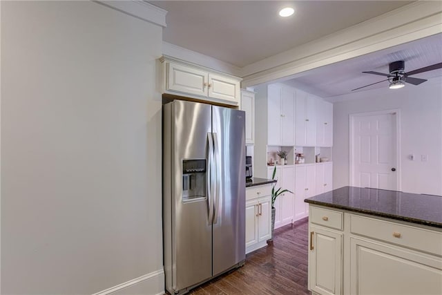 kitchen with stainless steel fridge, ceiling fan, white cabinetry, dark hardwood / wood-style flooring, and dark stone counters