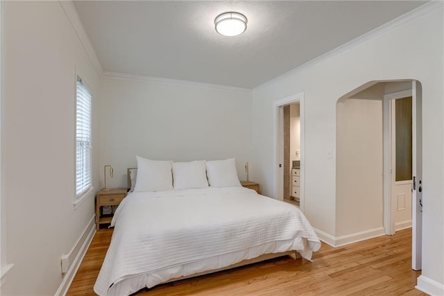 bedroom with crown molding and wood-type flooring