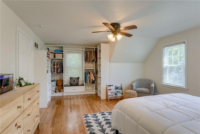 bedroom featuring vaulted ceiling, ceiling fan, and light wood-type flooring