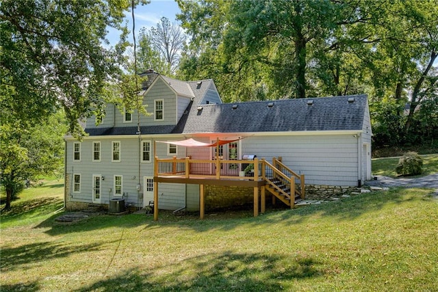 back of property featuring central AC unit, a deck, and a lawn