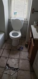 bathroom featuring tile patterned flooring and toilet