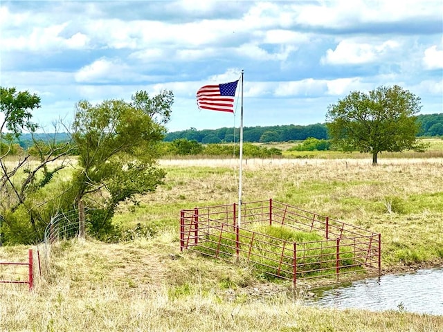 view of jungle gym with a rural view and a water view