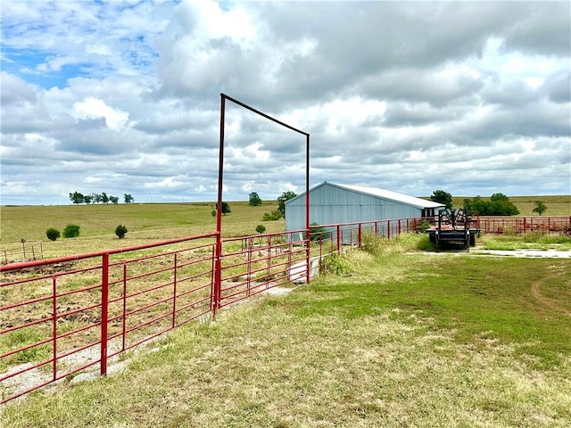 view of yard with an outbuilding and a rural view