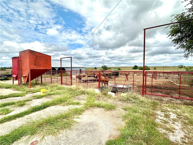 view of yard featuring an outbuilding and a rural view