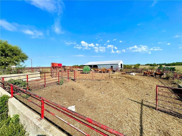 view of yard with a rural view and an outbuilding