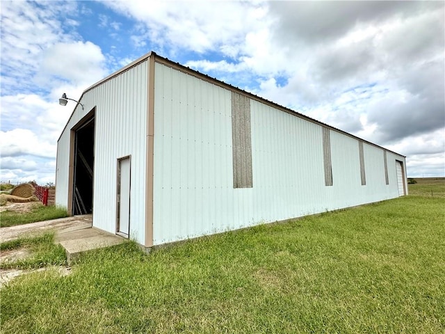 exterior space featuring a yard and an outbuilding