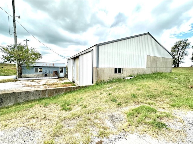 view of outbuilding with a yard