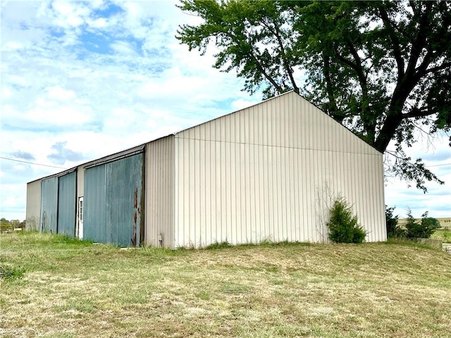 view of outbuilding with a lawn