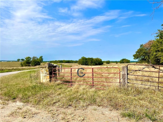 community / neighborhood sign with a rural view