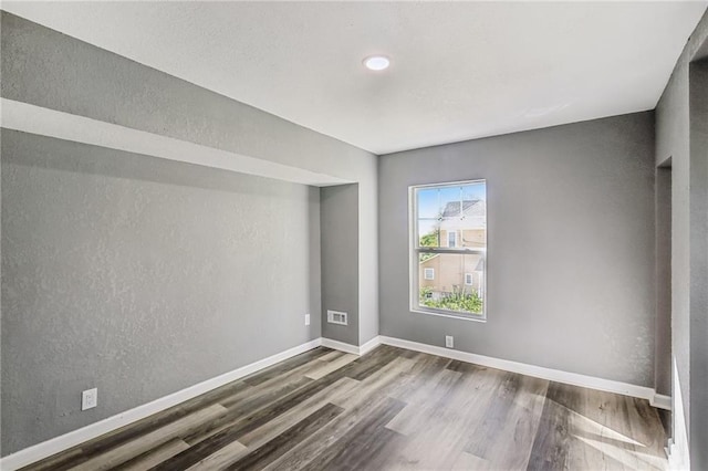 empty room featuring dark hardwood / wood-style flooring