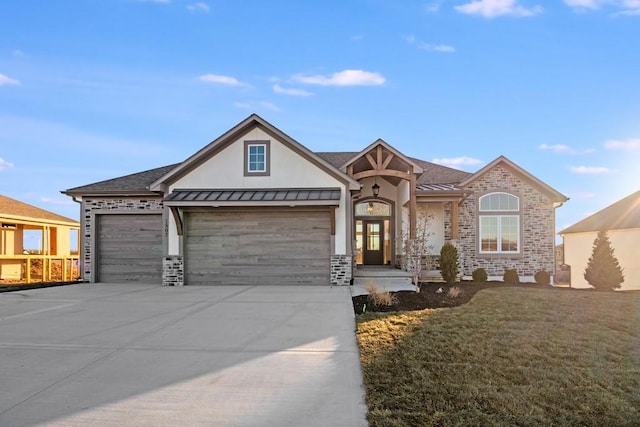 view of front of property featuring french doors, a front yard, and a garage