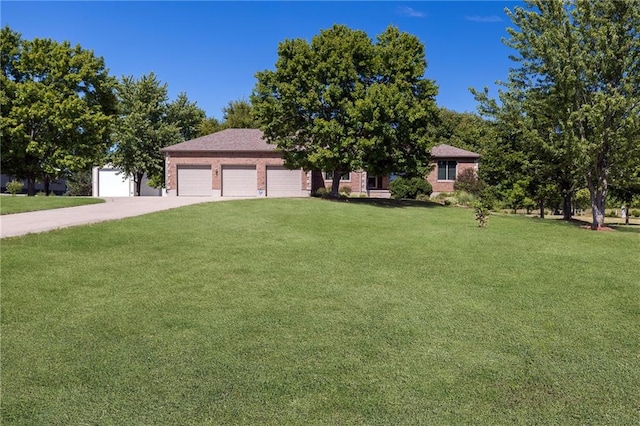 view of front facade with a front yard and a garage