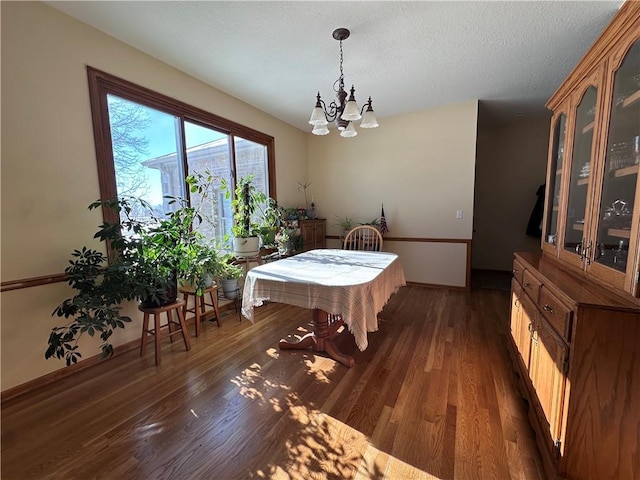 dining area featuring a chandelier and dark hardwood / wood-style floors