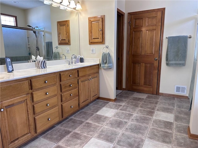 bathroom with walk in shower and vanity