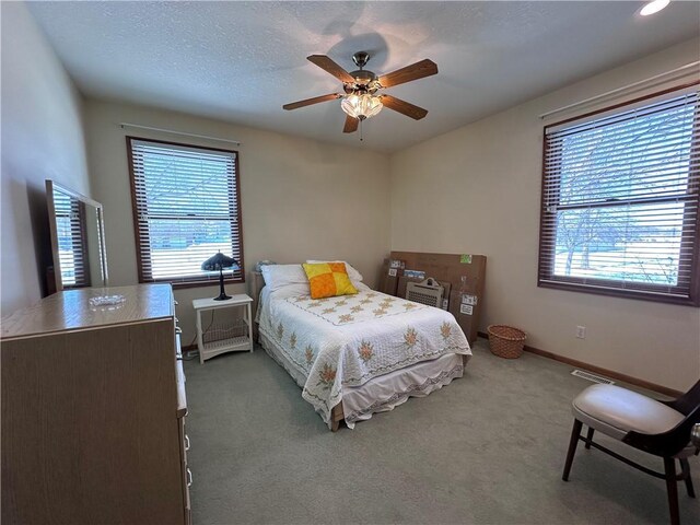 bedroom featuring ceiling fan and light colored carpet