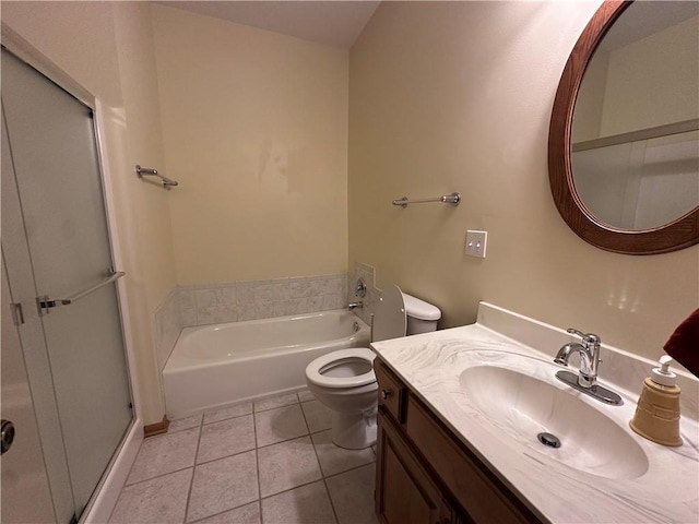 bathroom with toilet, tile patterned flooring, a bath, and vanity