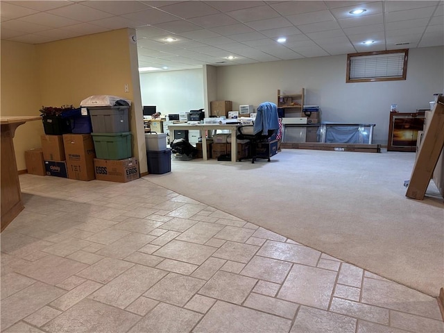 basement featuring light colored carpet