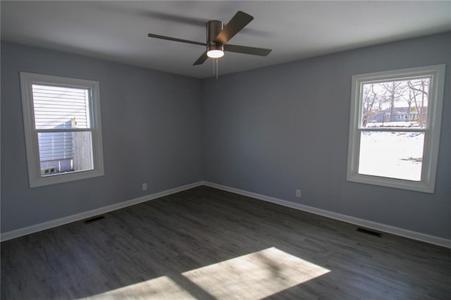 empty room featuring ceiling fan and dark hardwood / wood-style floors