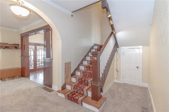 staircase with crown molding, carpet floors, and french doors