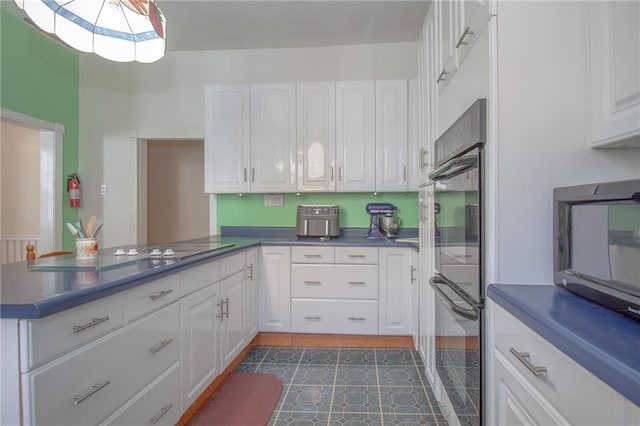 kitchen featuring black appliances, beverage cooler, white cabinets, and dark tile patterned flooring