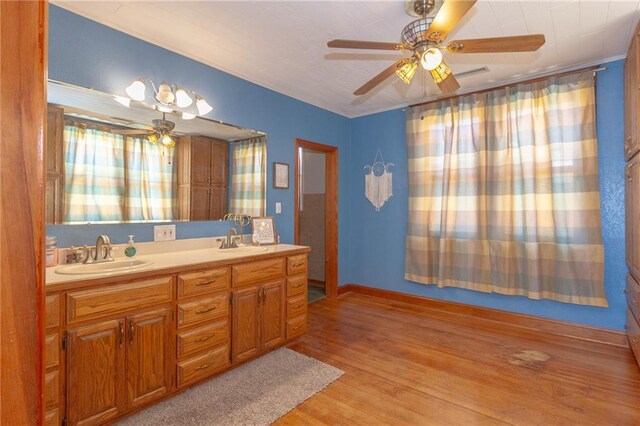 bathroom featuring vanity, hardwood / wood-style flooring, and ceiling fan