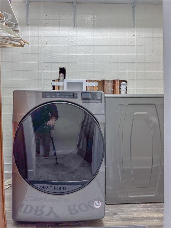 clothes washing area featuring washer hookup and wood-type flooring