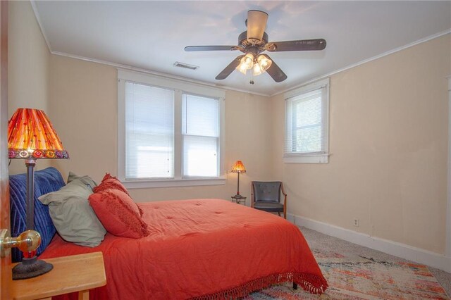 carpeted bedroom with crown molding, ceiling fan, and multiple windows