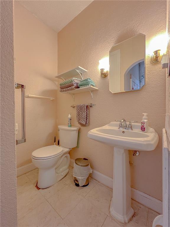 bathroom with tile patterned flooring and toilet