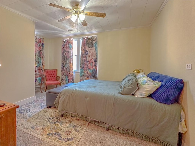 bedroom with crown molding, ceiling fan, and carpet