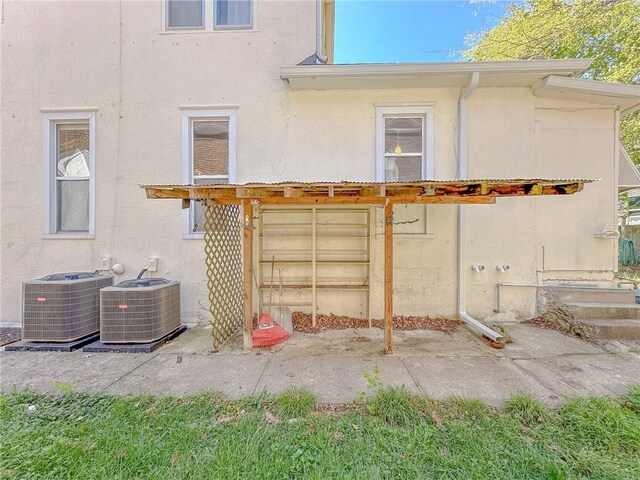 rear view of house featuring central AC