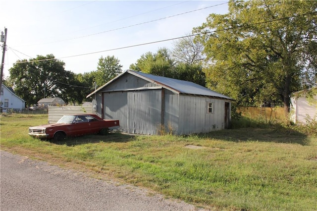 view of outbuilding with a yard