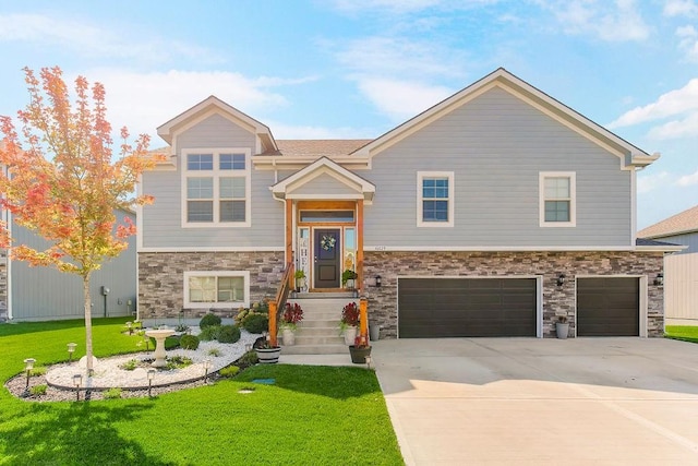 bi-level home with a garage and a front yard