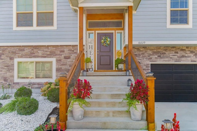 doorway to property with a garage