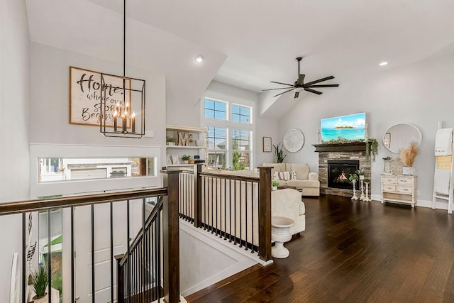 corridor featuring dark wood-type flooring, vaulted ceiling, and a notable chandelier