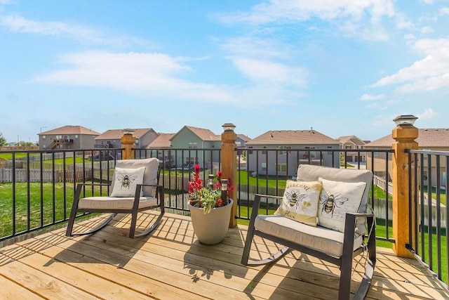 wooden terrace featuring a lawn