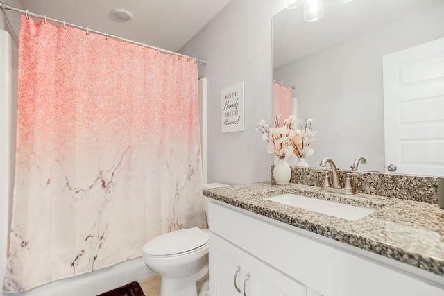 bathroom featuring vanity, toilet, and walk in shower