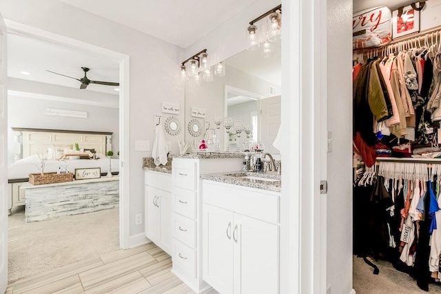 bathroom with ceiling fan and vanity