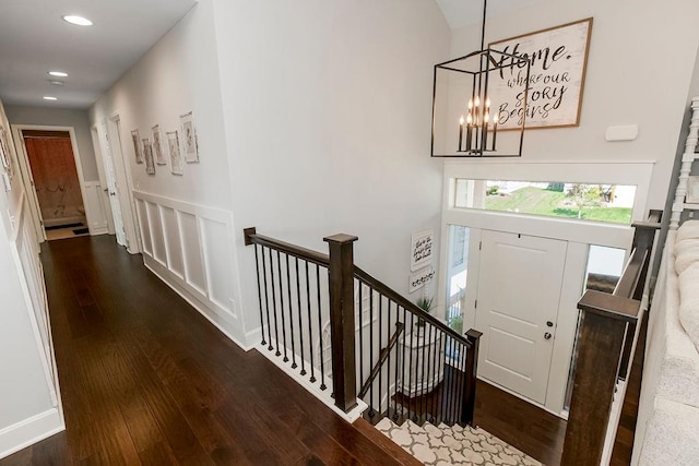 foyer entrance with dark wood-type flooring and a chandelier