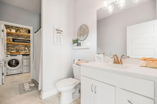 bathroom with toilet, independent washer and dryer, and vanity