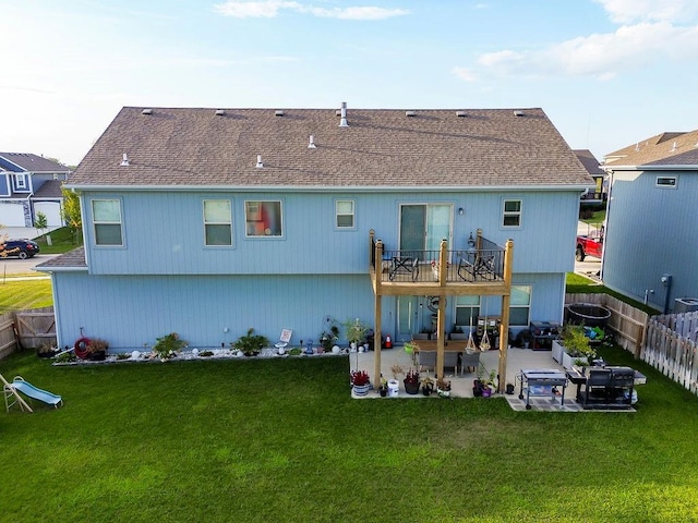 rear view of property with a yard and a patio